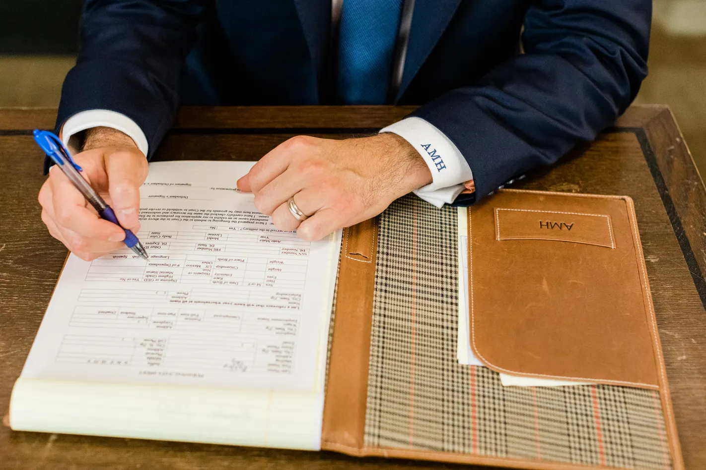 Austin Hagee reviewing and signing a case file at his desk