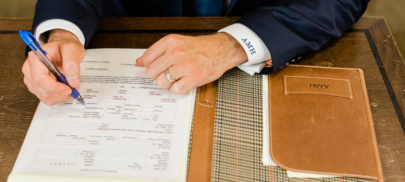 Austin Hagee reviewing and signing a case file at his desk