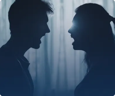 Silhouettes of a man and a woman facing each other in a heated argument